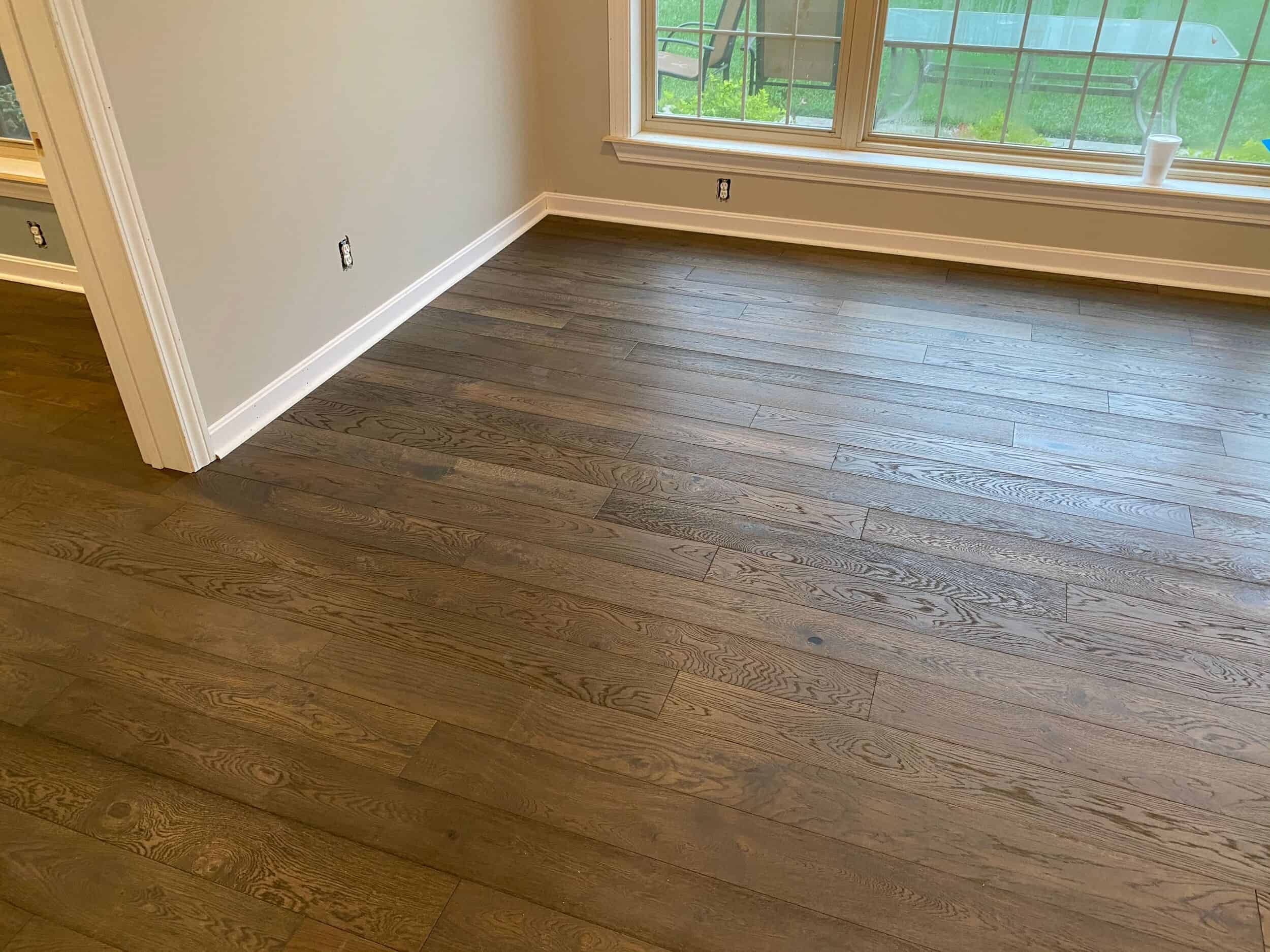 Room with wooden flooring and large windows